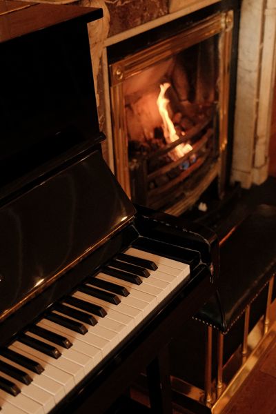 Luxury sitting room with piano and open fireplace at hotel in county limerick